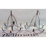 A pair of wrought iron six branch chandeliers, 90cm wide.