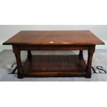 A 20th century oak two tier rectangular coffee table on block supports, 100cm wide x 47cm high.