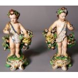 A pair of Continental porcelain figures of Putto, 12cm high, (a.f.), (2).