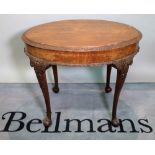 A Victorian style mahogany oval centre table on ball and claw supports.