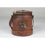 A 19th century leather bound shot carrier with a coat of arms to the front,