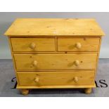 A 20th century pine dressing chest of two short and two long drawers on turned supports,