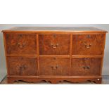 A 20th century pollard oak and walnut fronted six drawer side cabinet, with green leather inset top,