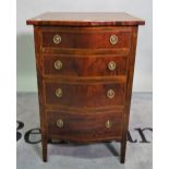 A Regency style mahogany serpentine chest of four short drawers on tapering supports,