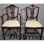 A set of seven George III style mahogany shield back dining chairs, to include one carver,