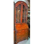 A 20th century mahogany bureau bookcase with arch topped astragal glazed doors over four long