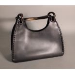 A Gucci black leather handbag, with ebonised wooden handle, 29cm wide.
