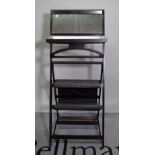 A 20th century black painted folding washstand with mirrored back, 53cm wide x 103cm high.