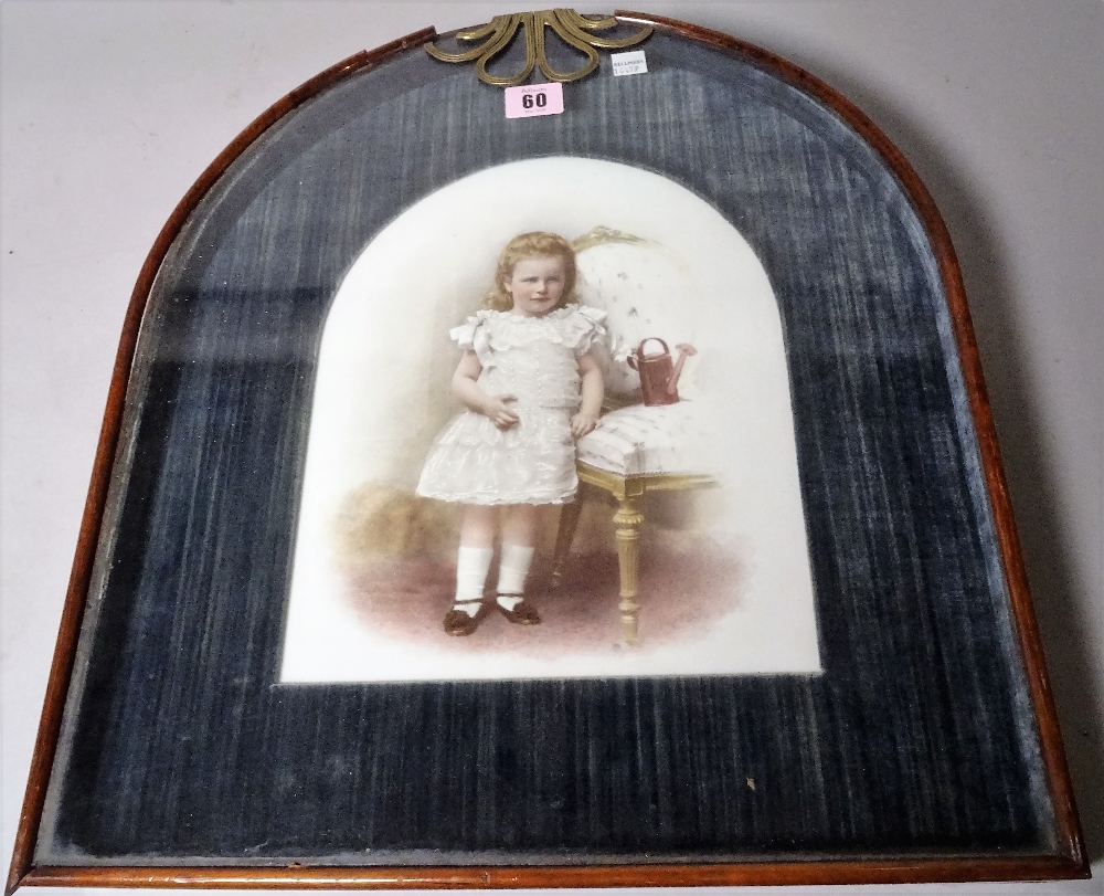 A late 19th century German porcelain plaque of a young girl within a ormolu mounted mahogany