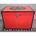 A 20th century red lacquer and studded lift top trunk, 93cm wide x 68cm high.