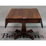 A 19th century mahogany drop flap sofa table with turned column and quatrefoil base,