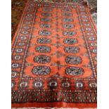 An Indian Bokhara rug, with madder field, 116cm x 80cm.