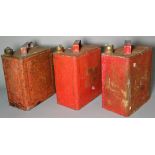 A group of three early 20th century red painted petrol cans, 25cm wide x 28cm high, (3).