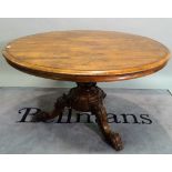 A Victorian rosewood circular tilt top breakfast table on three carved outswept supports,