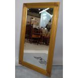 A gilt framed rectangular wall mirror with bevelled plate and reeded frame, 80cm wide x 141cm high.