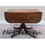 A George III mahogany drop flap Pembroke table with turned column on four outswept supports,