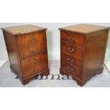 A pair of 20th century stained beech two drawer filing cabinets with inset tan leather tops,