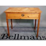 An early 20th century pine single drawer side table on tapering square supports,