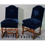 A pair of late 19th century Continental oak framed highback chairs with blue upholstery, (2).