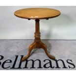 A George III style mahogany tripod table on a turned column on three downswept supports,