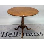 A George III mahogany tripod table on turned column with downswept pad feet, 82cm wide x 88cm high.