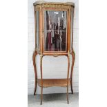 An early 20th century French gilt metal mounted vitrine, the marble top over single door,