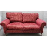 A modern roll arm sofa in patterned red upholstery on turned supports, 193cm wide x 83cm high.