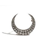 A Victorian diamond-set crescent brooch, claw-set with old mine-cut diamonds,