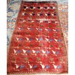 A Khoran rug, the burgundy field rows of pairs of lily flowerheads, a brown chequered border,