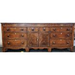 A large 18th century inlaid mahogany side cabinet with a pair of drawers over cupboards,