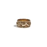 A yellow precious metal band ring, realistically cast with hounds chasing a fox,