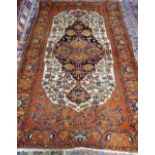 A Bakhtiari rug, Persian, the ivory field with a bold dark indigo medallion,