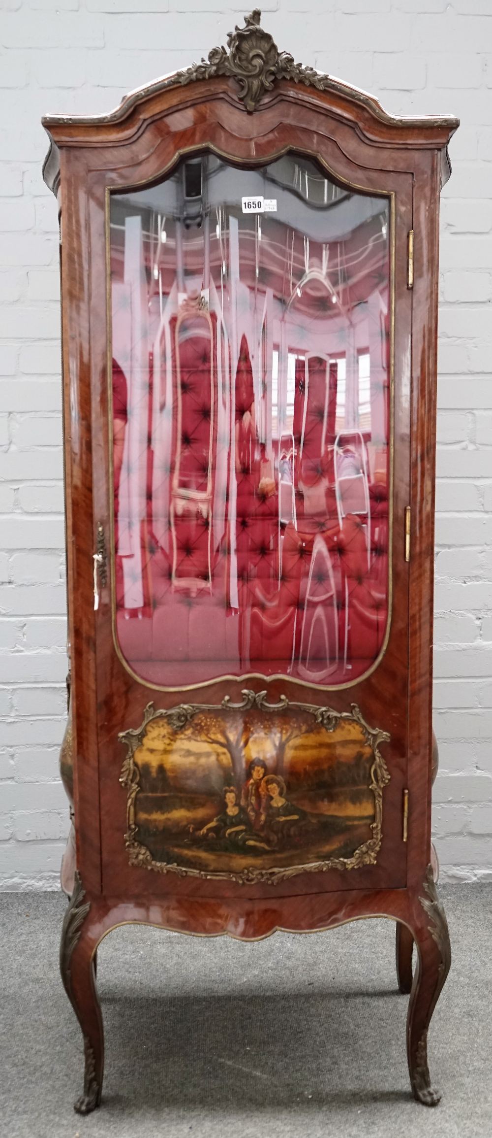 An early 20th century gilt metal mounted kingwood vitrine with serpentine door,