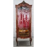 An early 20th century gilt metal mounted kingwood vitrine with serpentine door,