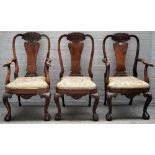 A pair of George I style carved walnut and walnut veneered elbow chairs and a matching standard
