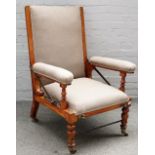 A Victorian mahogany framed reclining easy armchair on turned supports, 72cm wide x 106cm high.