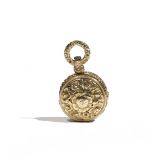 An early 19th century yellow precious metal pendant vinaigrette of circular form,