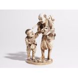 A Japanese ivory okimono of a man and boy, both standing, the man carrying an axe and hare, signed,