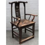 A 19th century Chinese hardwood open armchair, with carved splat and perimeter stretcher,