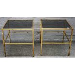 A pair of mid-20th century lacquered brass and smoked glass square two tier occasional tables,