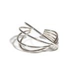 A modern silver torc bangle by Georg Jensen, of four bar cross-over design,