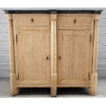 A 19th century Continental bleached oak side cabinet, with faux slate top and turned columns,