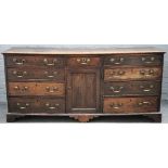 A George III oak low dresser, the rectangular top above three frieze drawers with six drawers below,