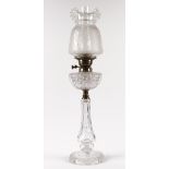 A Victorian cut glass oil lamp base, with brass mounts and later etched glass shade, 76cm high.