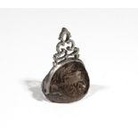 A 19th century silver mounted smoky quartz fob seal, intaglio carved to three sides with a monogram,