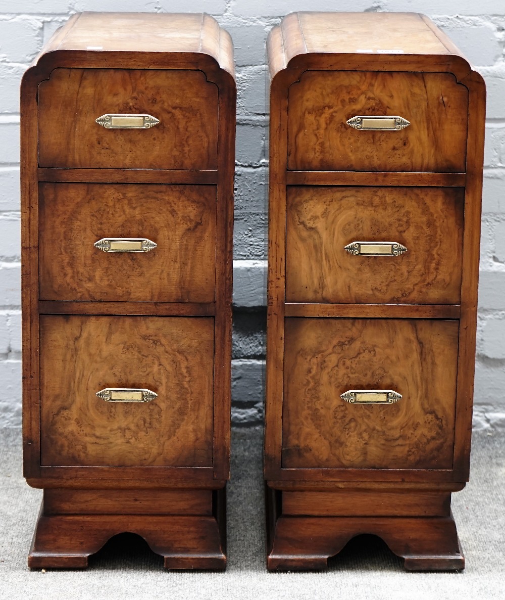 A pair of 1930s walnut three drawer bedside tables, on bracket feet, 27cm wide x 69cm high.