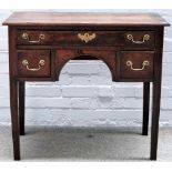 A mid-18th century oak lowboy with three drawers about the arch frieze, on square supports,