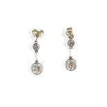 A pair of diamond pendant earrings, the yellow precious metal earstuds,