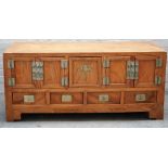A 19th century Chinese camphor wood low cabinet, with five cupboards over four drawers,