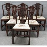 A set of six 18th century oak pierced splat back dining chairs, on tapering square supports,